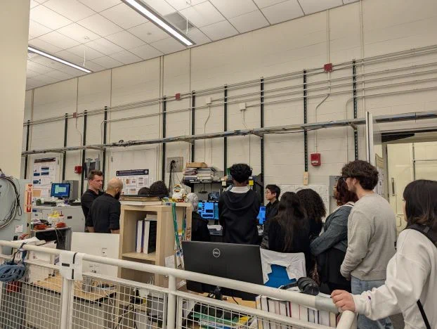 Students listen to Dr. Viliam during a tour of Prof. Yazdani's lab