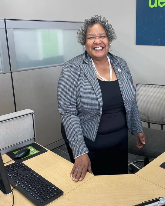 Hazeline standing at her desk at H&R Block