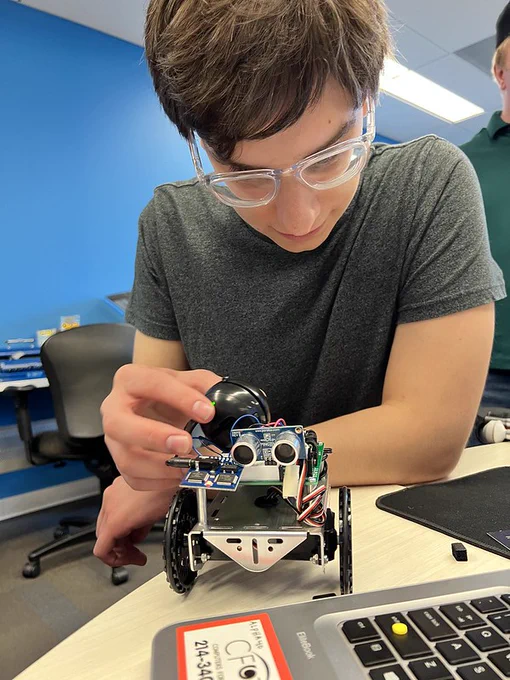 Elvis is working on a robot that he built at Alphapointe's Technology Camp. 