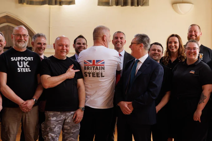 Prime Minister Keir Starmer speaks with workers and union representatives near the British Steel plant in Scunthorpe.