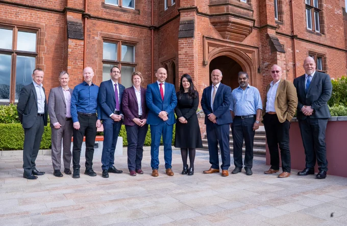Image shows the event's speakers and organisers pictured outside Riddel Hall. 