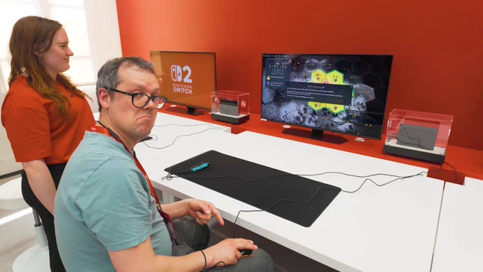 Mike plays Civ 7 on the switch, using its mouse functionality and using it on his knee. He looks impressed at how well it works.