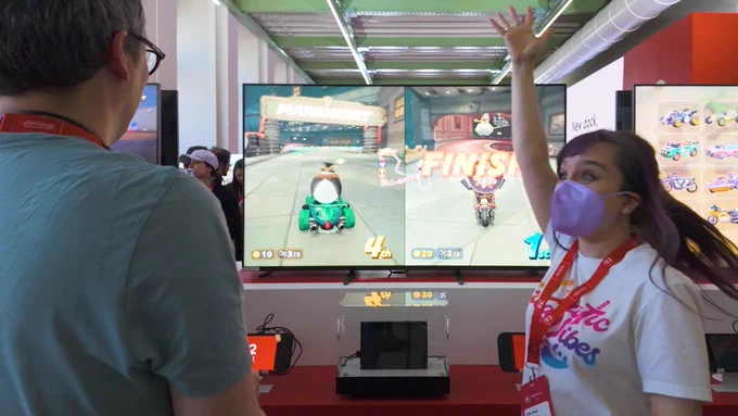 Mike and Ellen Play Mario Kart World, Ellen celebrates finishing 1st as Mariachi Waluigi, turning to Mike with her hand raised and wide eyes. Mike is a respectable 4th of 24.