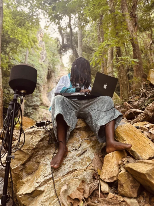 My Afro-Spiritual Groove and sound practice requires more than just composing and recording.

The environment must be distilled, 
Its essence, harnessed in the sound.
The rhythm must flow like the waters running through the rocks.

Spirit must be felt.
Spirit is not contained.
Spirit must be yearned.
Spirit must be earned.

Music is spirit.
Wherever it flows,
there I shall seek, 
and my feet grounded!

To become part of the natural rhythm,
Plugged into a current that’s both spiritual and sonic.

Where Waters that fall, are framed beautifully by trees and rocks
a sacred immersion.

And myself in a posture; calm, grounded, and focused, 
A ritual in process.
A communing with earth and sound.