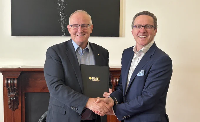 Calum Drummond shakes hands with Atmo Biosciences CEO Mal Hebblewhite.