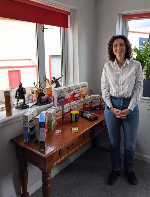Wendy stood in front of a range of Quaker Oats products.