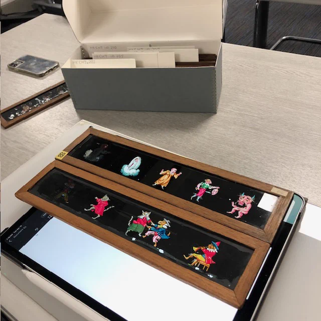 characterful hand-painted wooden sliders on a light box