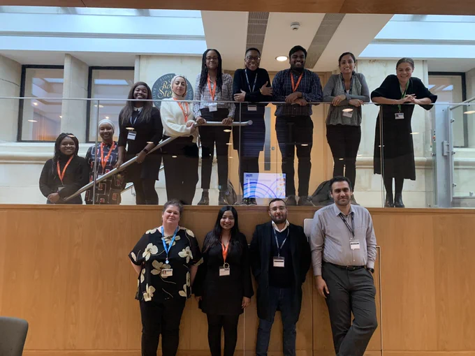 Group of RadReach mentors and mentees posing on stairs inside the RCR building.
