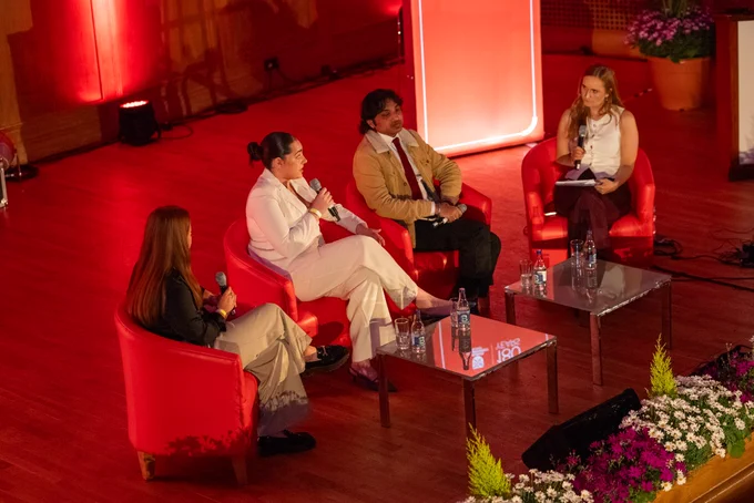 Image shows the panel of young people on stage with journalist Claire Graham. 