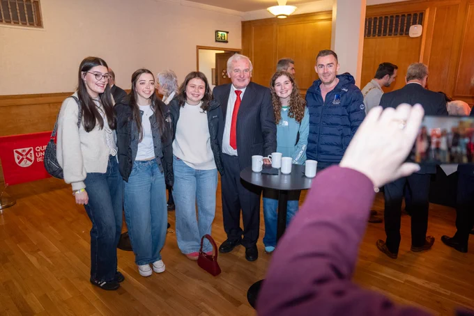 Image shows a group of young people being photographed with Bertie Ahern, Former Taoiseach.