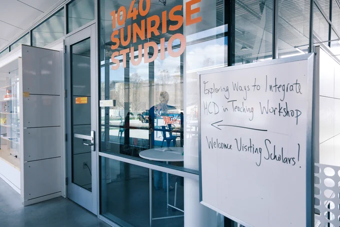The Siebel Center for Design hosted a workshop on human-centered design in the Sunrise Studio (Room 1040) for the Future Professors Programme (FPP) and the Accelerated Academic Mentors Programme (AAMP) and staff members from Global Education and Training. In the photo there is a white board with the workshop name and "Welcome Visiting Scholars" written on it that sits in front of the Sunrise Studio entrance. 
