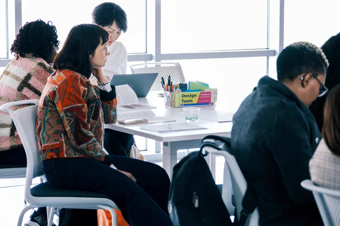 Participants in the Future Professors Programme (FPP) and the Accelerated Academic Mentors Programme (AAMP) and staff members from Global Education and Training sit and listen to Dr. Carrie James, a Siebel Center for Design (SCD) instructor, during a workshop inside the Sunrise Studio (Room 1040) at SCD. 