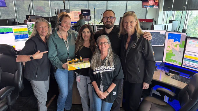 Staff from Jeffcom 911 posing for a photo. Also, Jeffcom 911 telecommunicators working.
