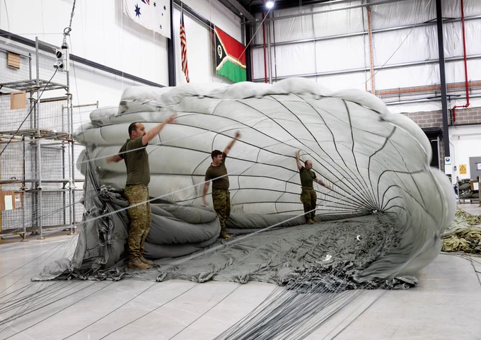 Members of Aerial Dispatch Element of Joint Logistics Command inflate a parachute to prepare it for repacking at the Joint Logistics Unit-East facility at Moorebank, NSW.