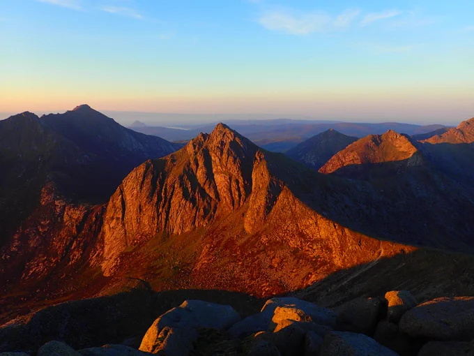 Cir Mhor mountain at sunrise. It is glowing a deep copper colour. 