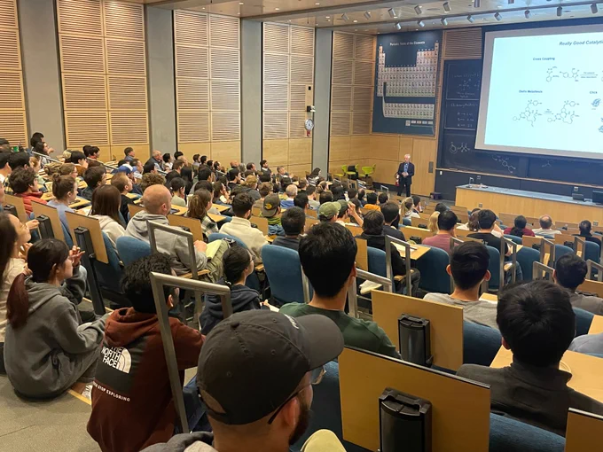 Taylor Auditorium packed with students and faculty at Princeton Chemistry, Eric up front by the screen.