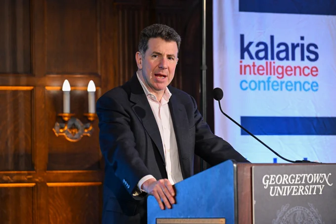 A person speaking at a podium at the Kalaris Intelligence Conference hosted by Georgetown University.