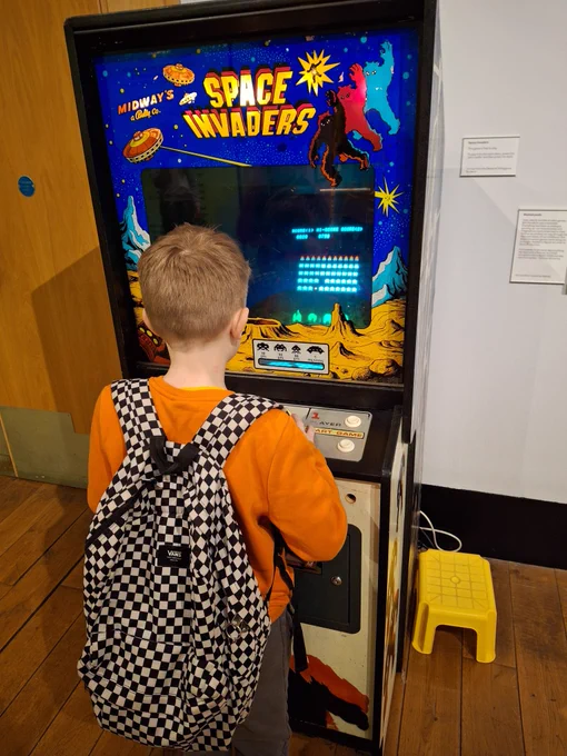 After having fun exploring the museum, the young person enjoyed a game of Space Invaders.