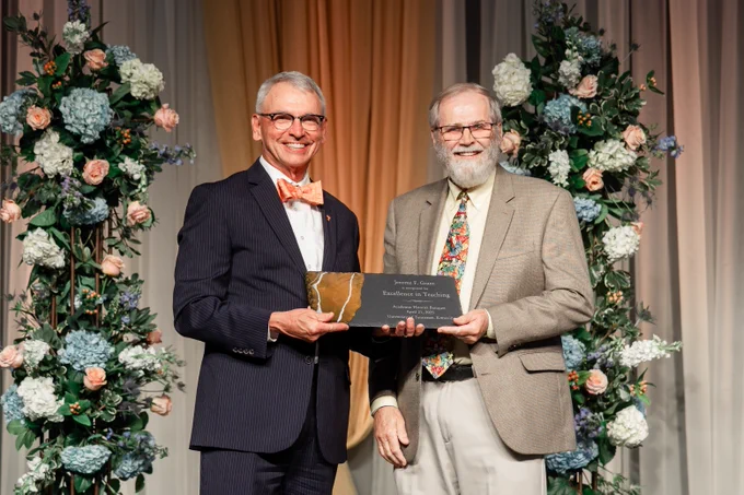 UT Provost John Zomick and EPP Professor Jerome Grant holding one of two award plaques at the annual Academic Honors Banquet.