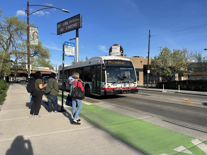 Cta bus picks up passengers at the Spaulding stop on Belmont