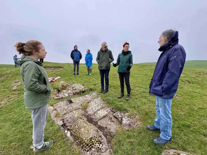 Participants discussing the rock art at High Banks, Kirkcudbright
