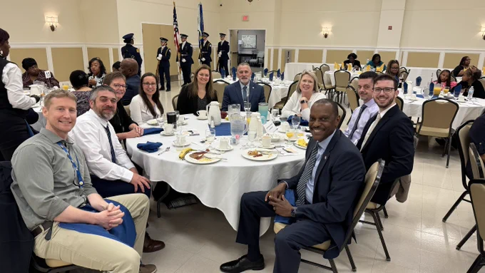 Image of CIO Greg Lane (front, left) and 9 members of DTI's Leadership Team at the Governor's Prayer Breakfast.
