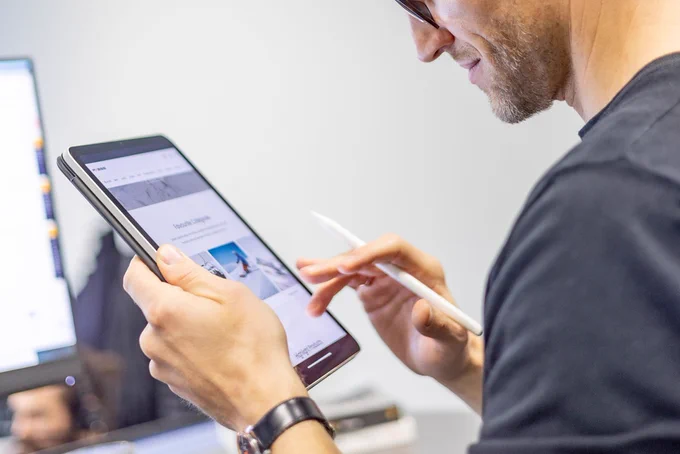 Close-up of a person using a tablet. 