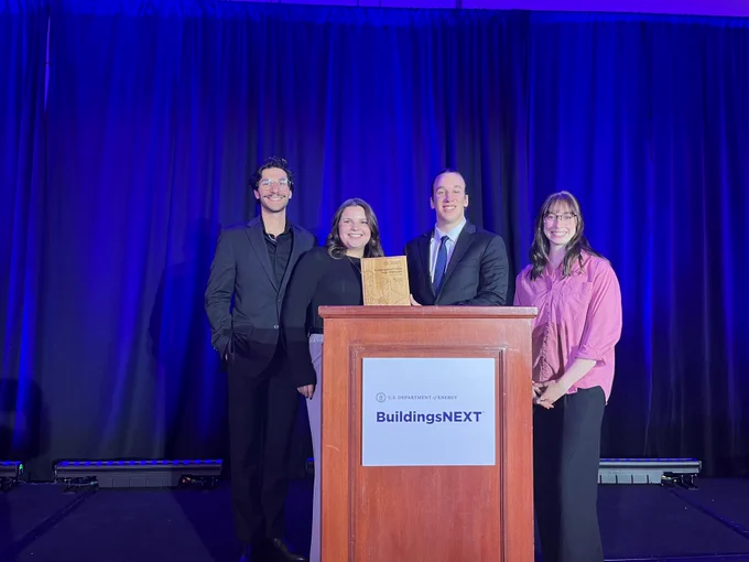 Photo of the BuildingsNEXT team getting an award. 