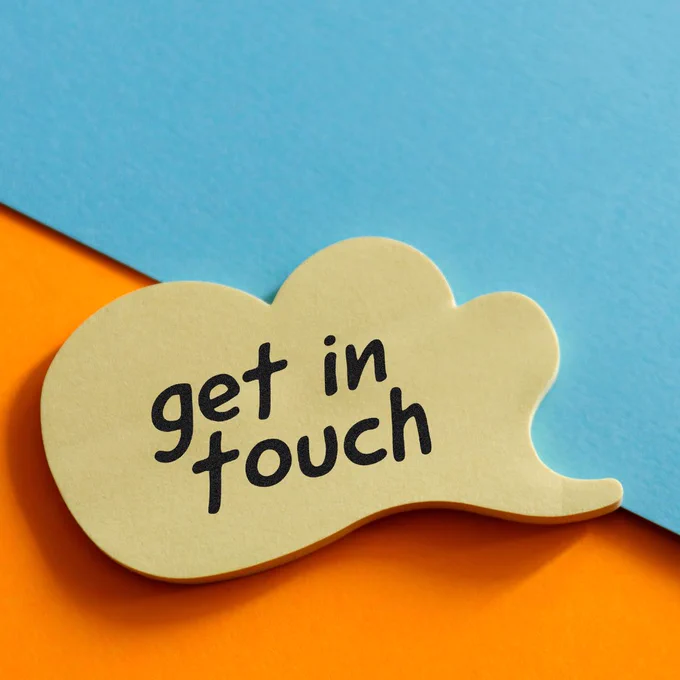 Get in touch written in black on wooden thought bubble.  Orange and blue background.