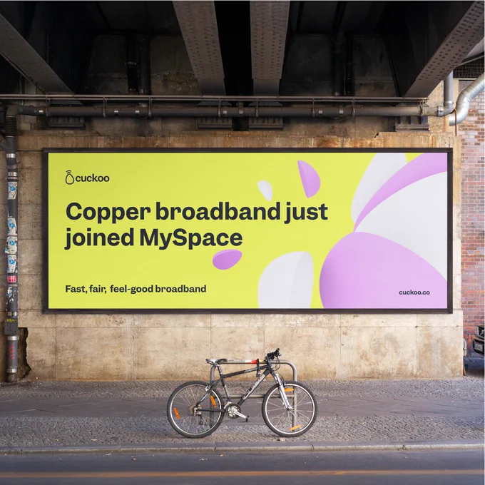 Billboard from Cuckoo featuring an advertisement about copper broadband joining MySpace, placed under a bridge with a parked bicycle in front.