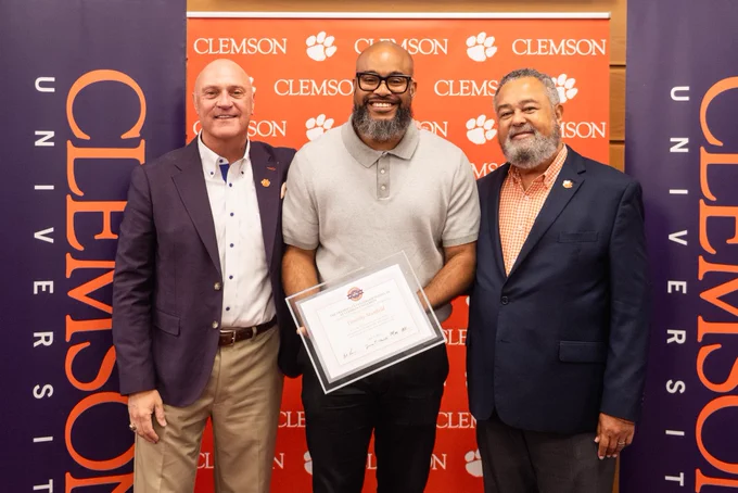President Clements and Max Allen posing for a photo with a President’s Leadership Institute graduate.