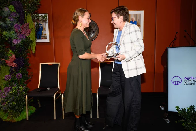 Carol Mudford, Winner and The Hon. Jodie Harrison MP (NSW Minister for Women) shaking hands and exchanging an award at the AgriFutures Rural Women's Award ceremony.