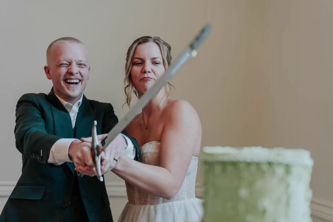 Wedding Reception of Alannah Hall and Rae Serbeck (2025). Rae and Alannah using a sword to cut there wedding cake 🗡️