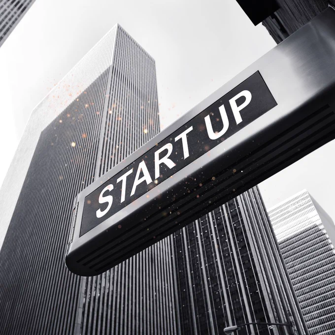 Start Up sign by skyscrapers with shimmer effect.