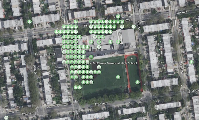 A satellite map showing Monsignor McClancy Memorial High School in Queens, New York, with markers indicating tree height observation locations made by students. The green markers are distributed across the school grounds, particularly around the athletic field, with streets and surrounding areas labeled. This map is part of the GLOBE Observer Trees Tool project, where students are measuring tree heights to complement measurements made from satellites. 