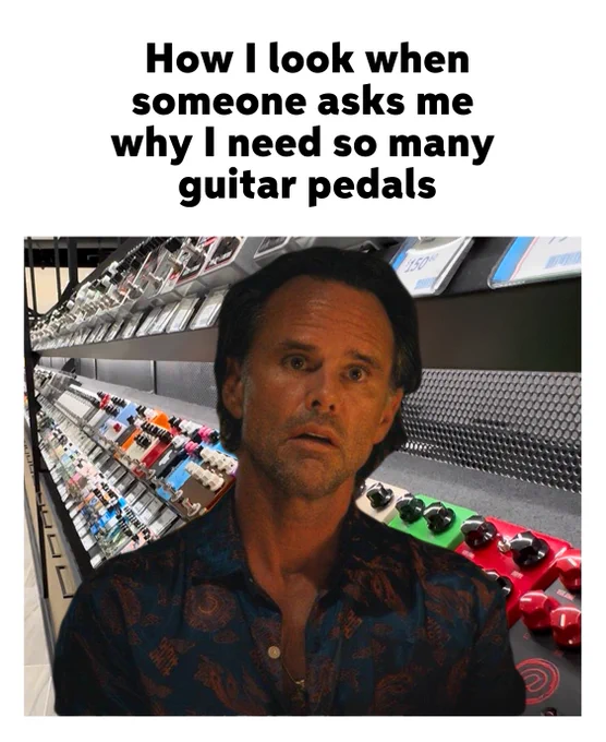 Image of actor Walton Goggins with a surprised expression, with a large collection of colorful guitar pedals.
