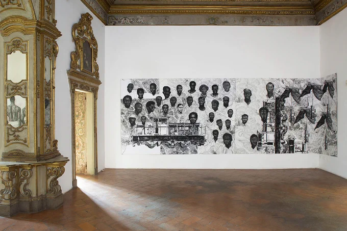 Black and white mural of people on display inside a stately home

