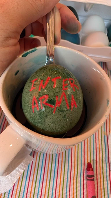 Dyed egg in a cup - with words for Inter Arma on the shell. 
