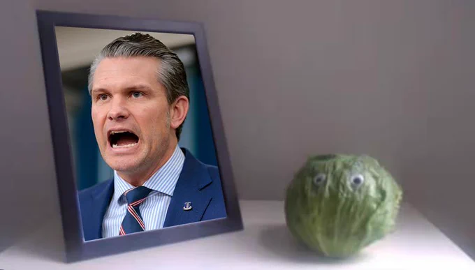 A framed photo of Pete Hegseth making a distressed face next to a head of lettuce with googly eyes, placed on a plain surface.