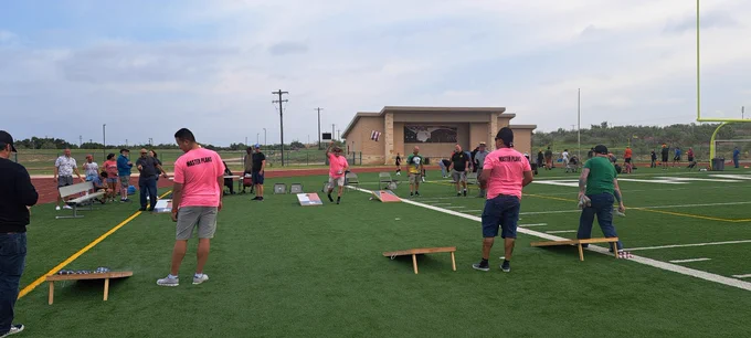Competitors try to best one another during the cornhole tournament at the 20th Annual Garrison Org Day at Fort Cavazos.