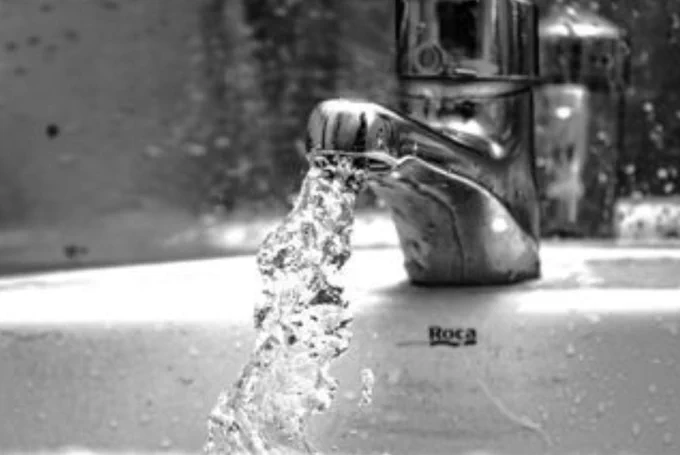 Water flows from a bathroom tap.