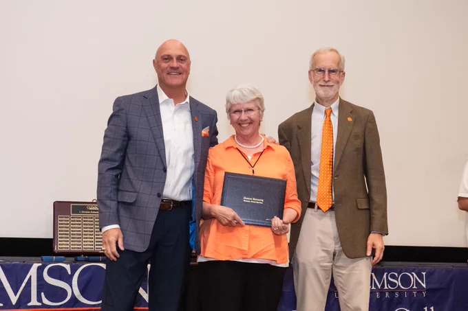 President Clements and Provost Jones posing for a photo with a member of the Emeritus College.