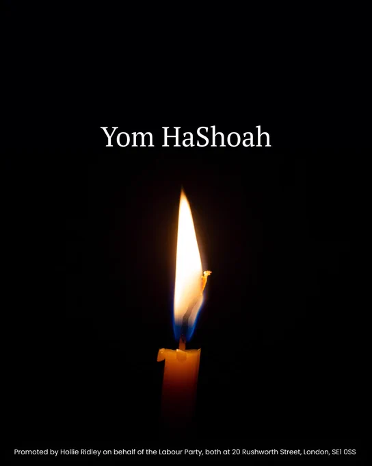 A single lit candle against a dark background, with the text "Yom HaShoah" above the flame.