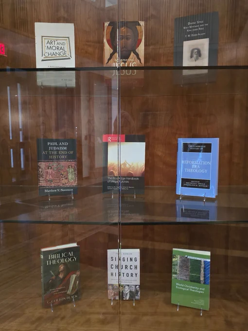 photo of new books by Princeton Seminary faculty -- Afe Adogame, Dale C. Allison Jr., Kenneth G. Appold, Raimundo C. Barreto, C. Clifton Black, Ki Joo "KC" Choi, F.W. "Chip" Dobbs-Allsopp, Matthew V. Novenson, and Paul Rorem  -- on display in a glass case in Wright Library
