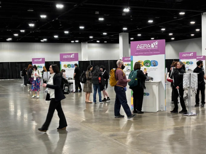 Attendees stand at kiosks and walk around the registration area