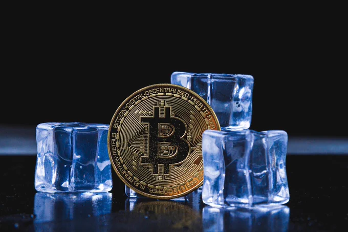 Bitcoin surrounded by ice cubes symbolizing frozen funds — promote Crypto Dispensers Bitcoin ATM at 7th Heaven Convenience Store in Chillicothe, Missouri where you can buy Bitcoin with cash instantly, no delays, up to $25K per day. 