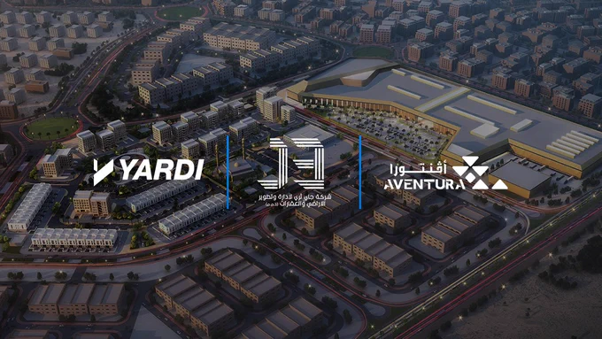 Aerial view of a large urban development at dusk, featuring the logos of Yardi, J3, and Aventura prominently displayed.