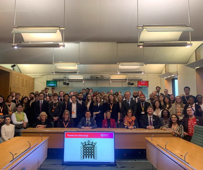 A group of 75 people in a room in UK Parliament for the meeting of the APPG for Students on Funding. At the front of the room are the conveners of the APPG including Dr Jo Grady, Alex Sobel MP, Abtisam Mohammad MP, NUS VPs Alex Stanley and Saranya Thambirajah
 