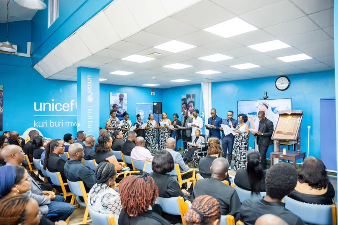 A group of people recite a poem as participants keenly follow.