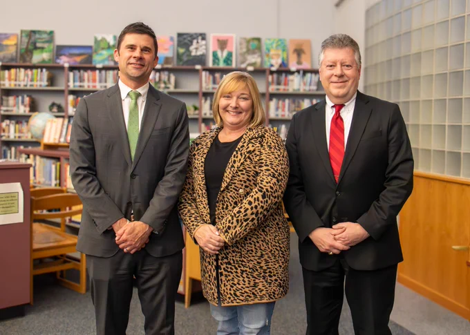 Phil Johnson, pictured at left, next to Board President Jennifer Michalec and current superintendent Daniel Pacos. 